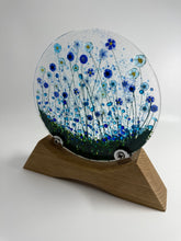 Load image into Gallery viewer, Handmade Fused Glass Round/Disc Blue Flower Ornament in a handmade Oak stand
